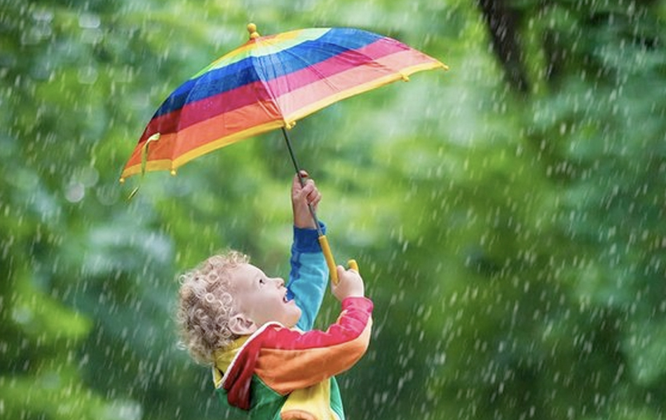 Kid holding umbrella in rain