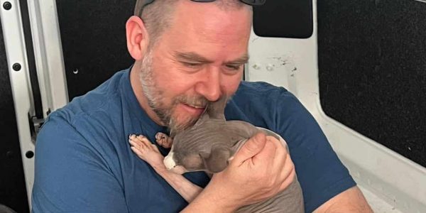 James with his pet cat, Loki, reuniting from a move from Australia to Texas.